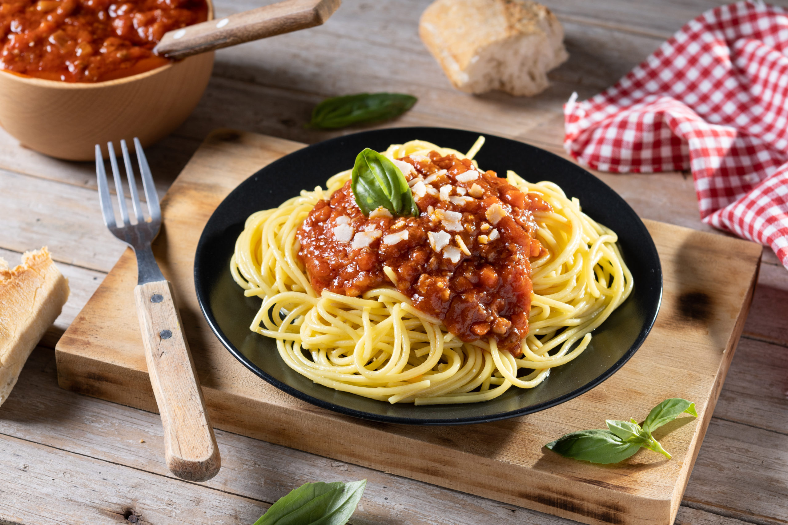 Spaghetti with bolognese sauce on wooden table